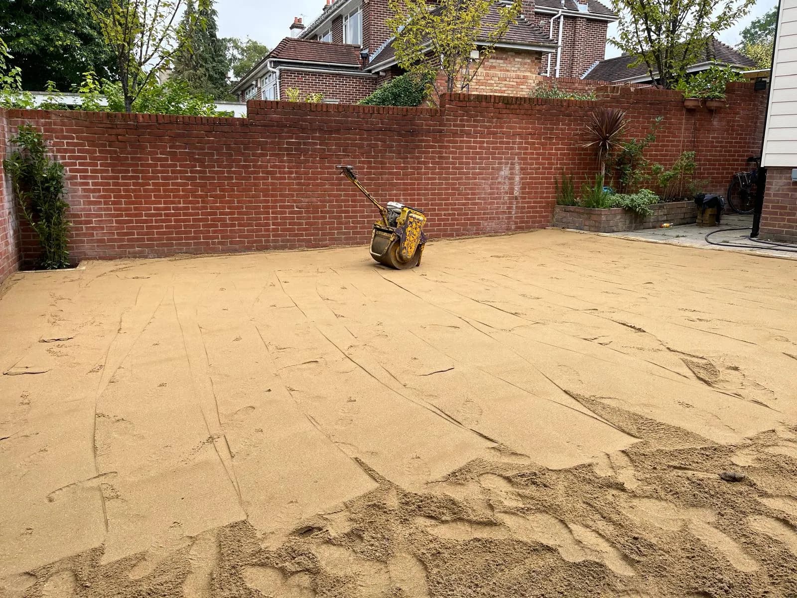 Finished artificial lawn against the garden wall