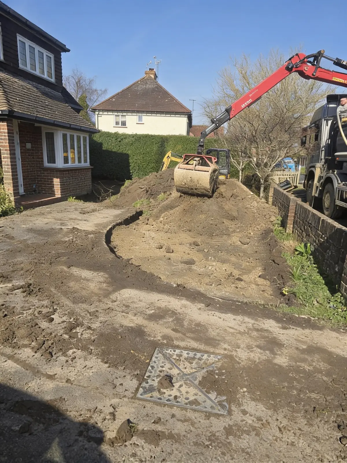 Excavating and carting away the old concrete driveway