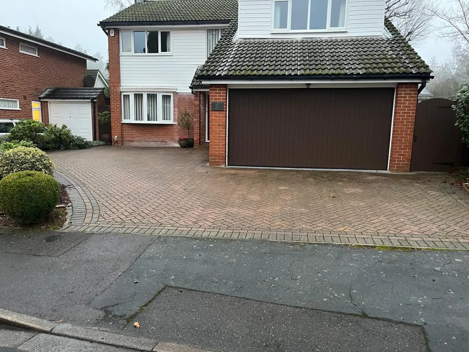 The old, faded block paving driveway before the works