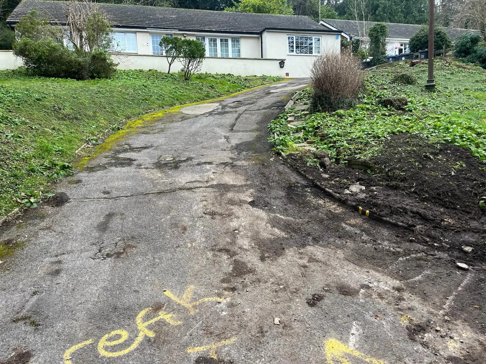 The cracked, worn driveway before the works