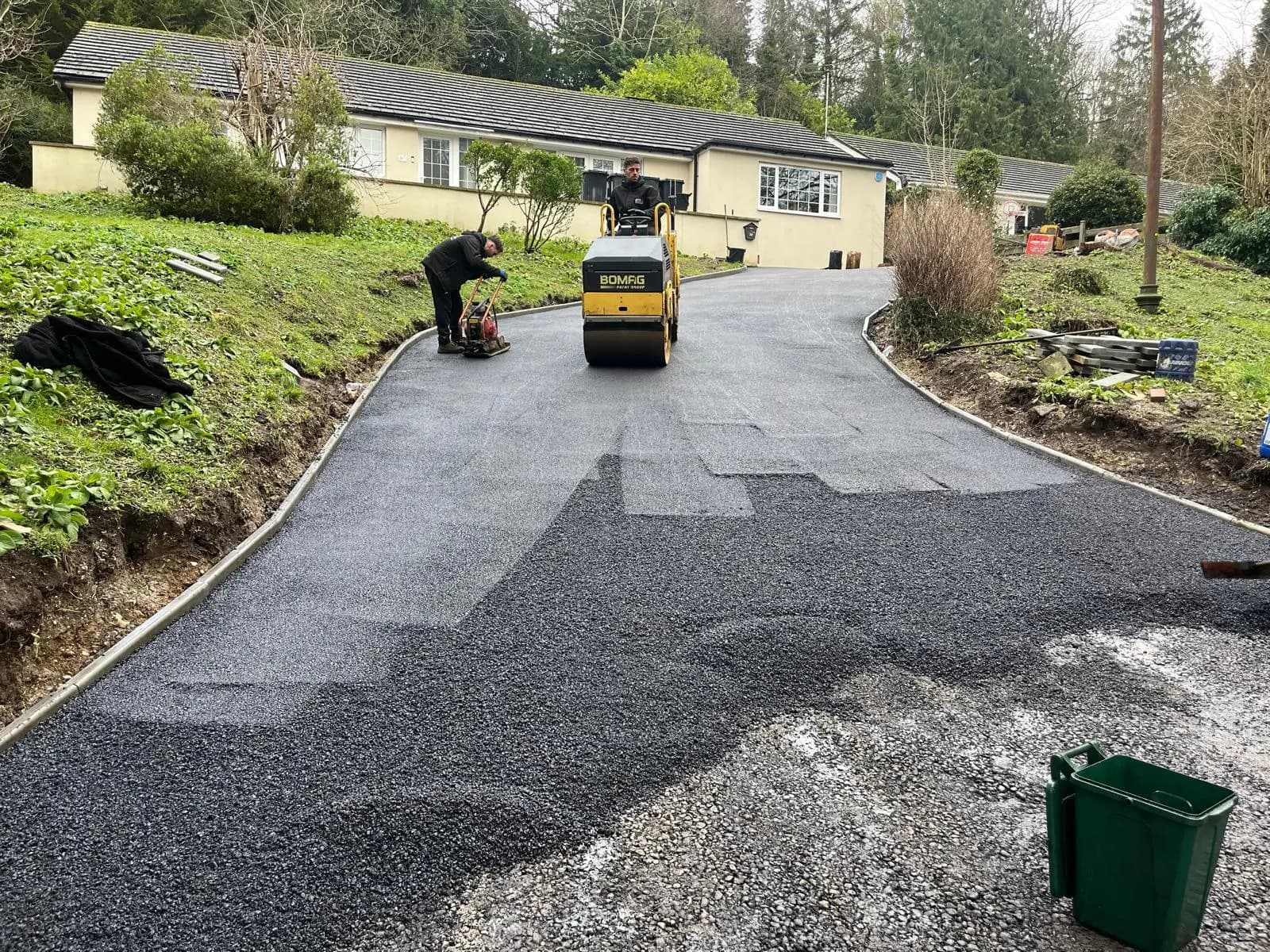 Rolling the new tarmac on the lower section of the drive