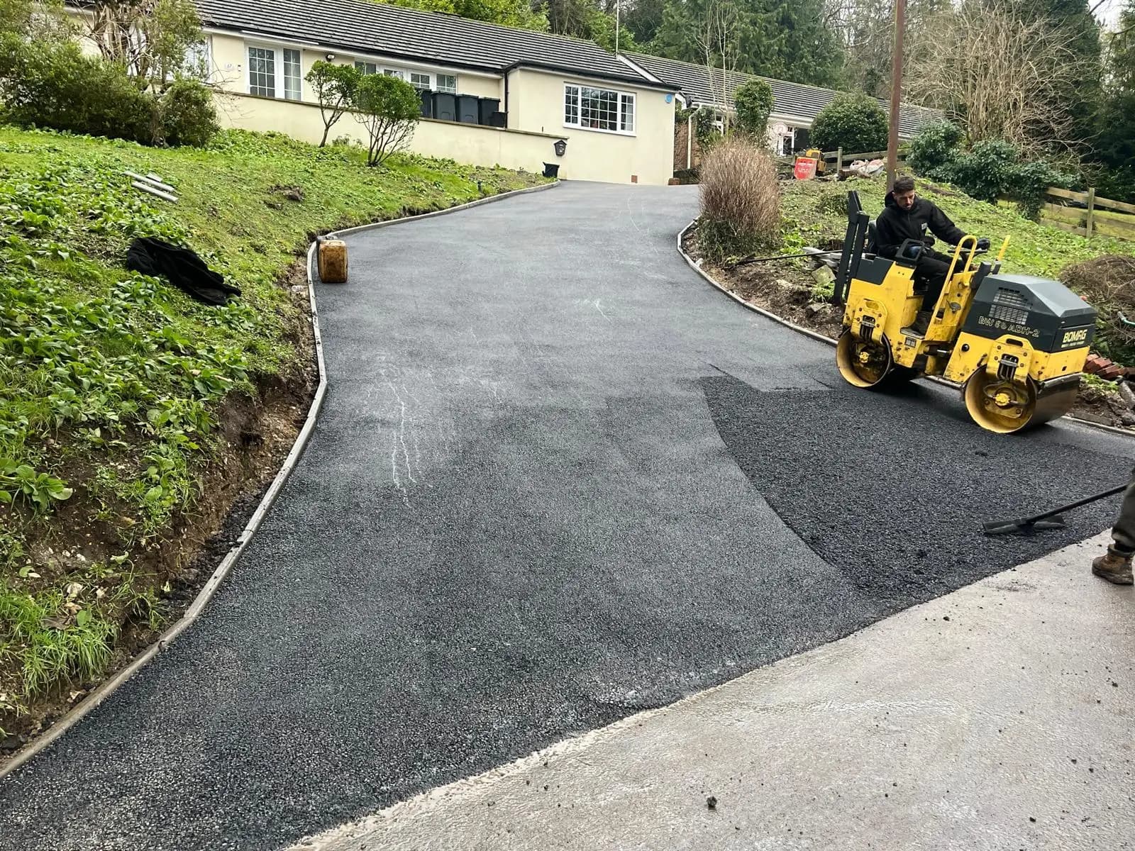 Compacting the new tarmac surface with the roller