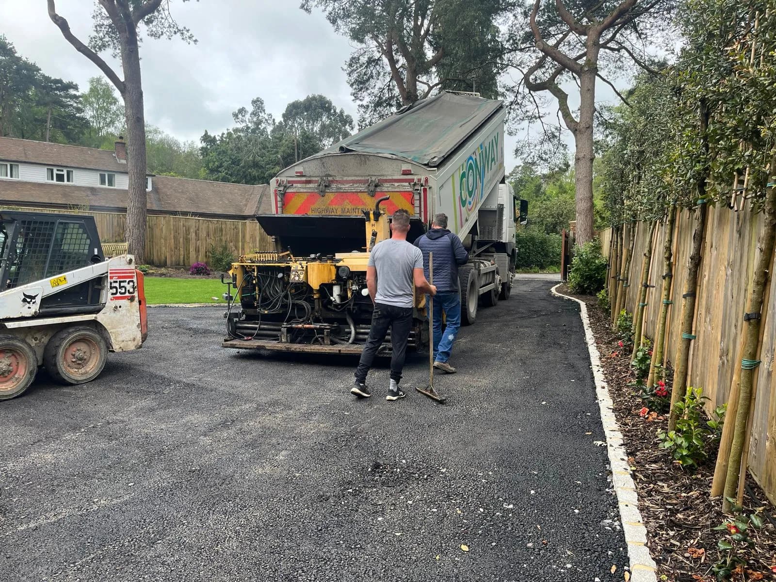 Machine-laying the fresh tarmac up the sweep of the drive