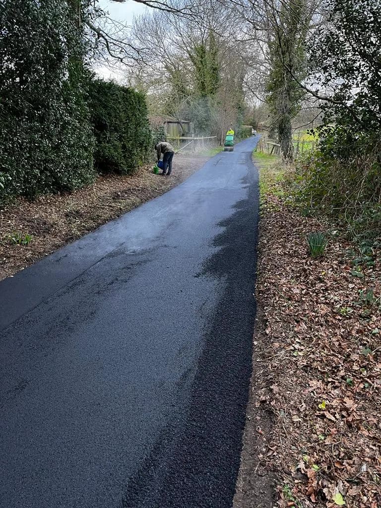 The resurfaced lane running through open ground