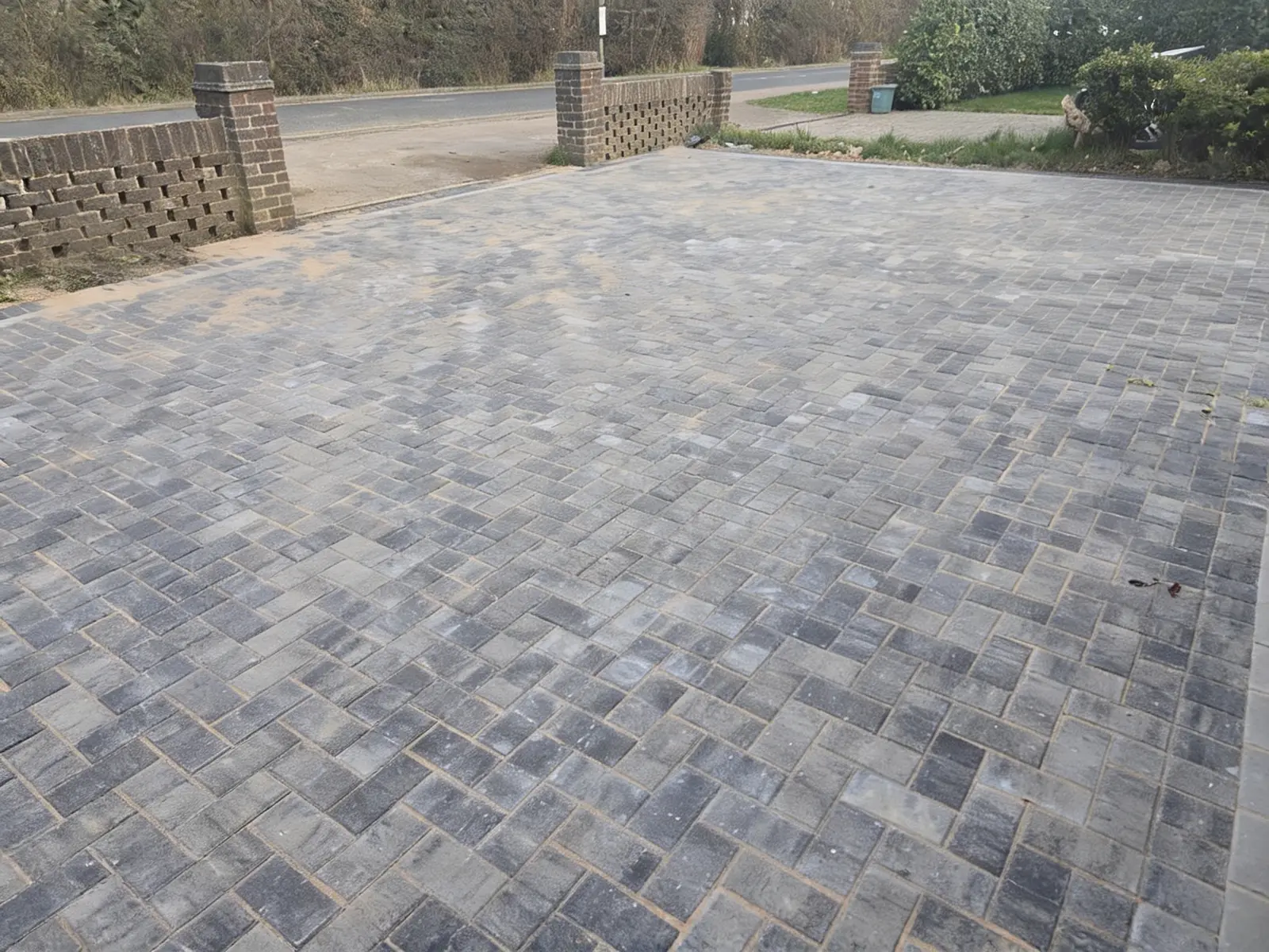 Charcoal block paving driveway laid in stretcher bond with a contrasting soldier-course border