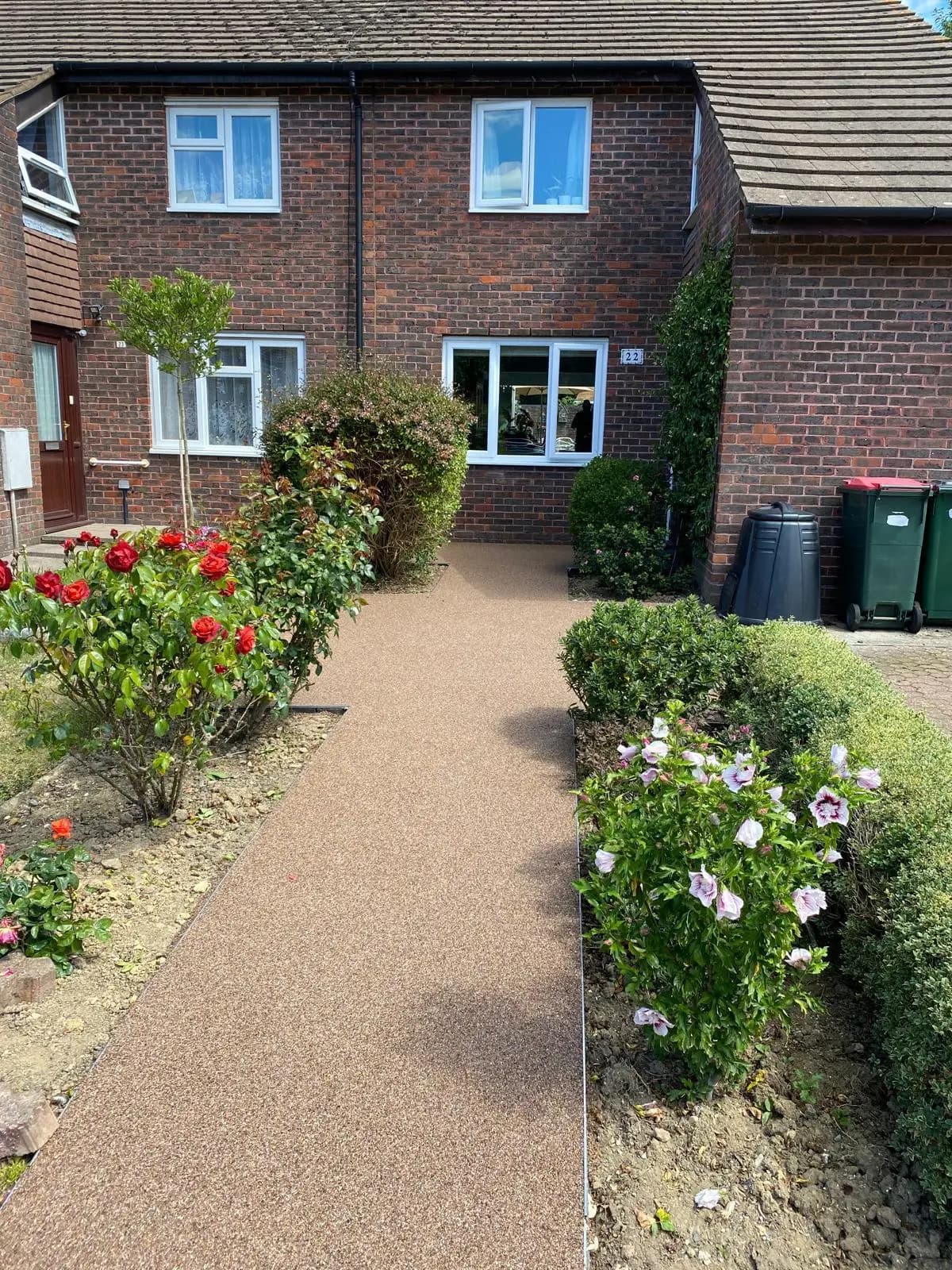 Finished golden resin-bound front path between planted borders in Crawley