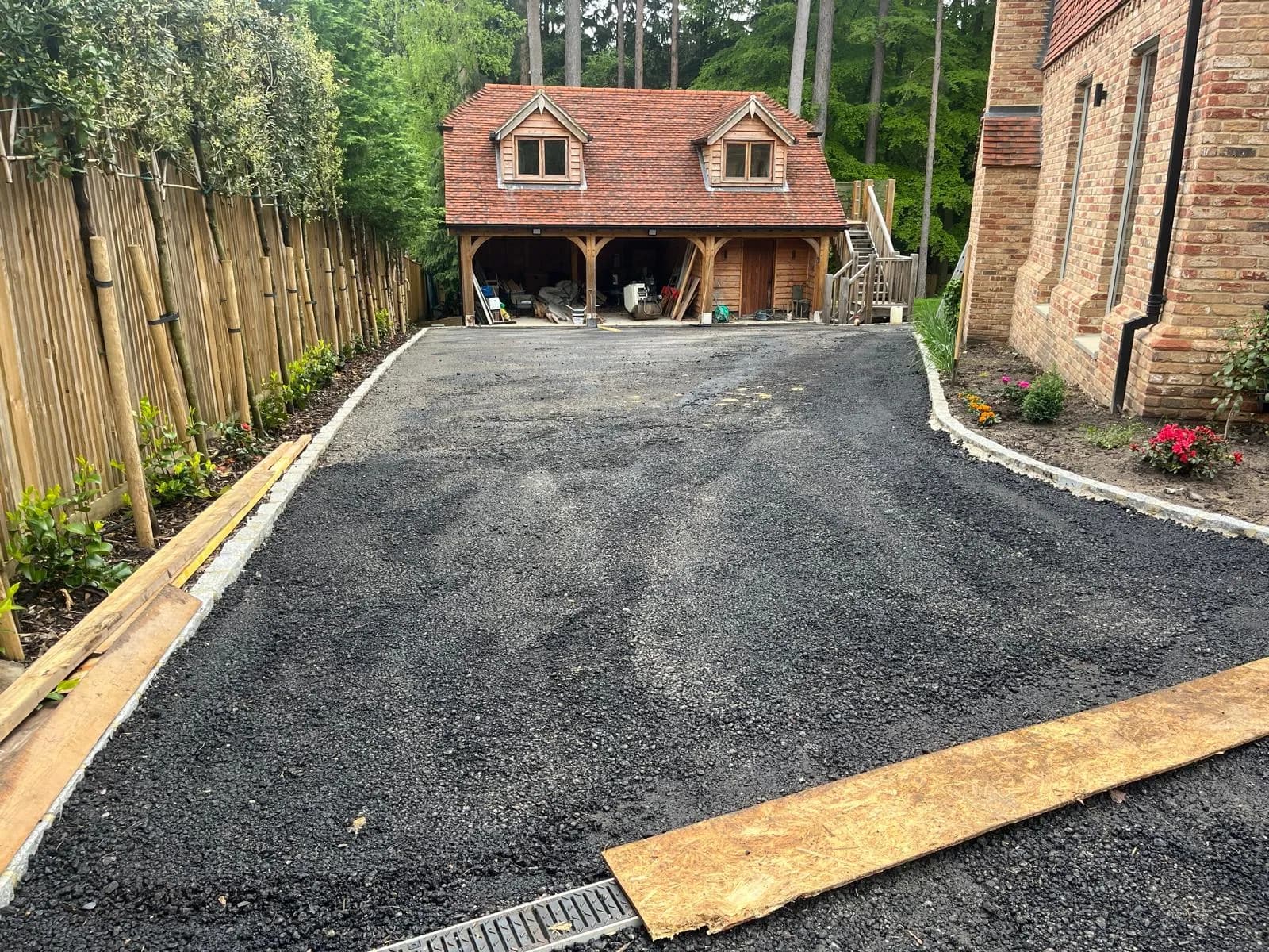 Finished sweeping tarmac driveway up to a country home in Surrey