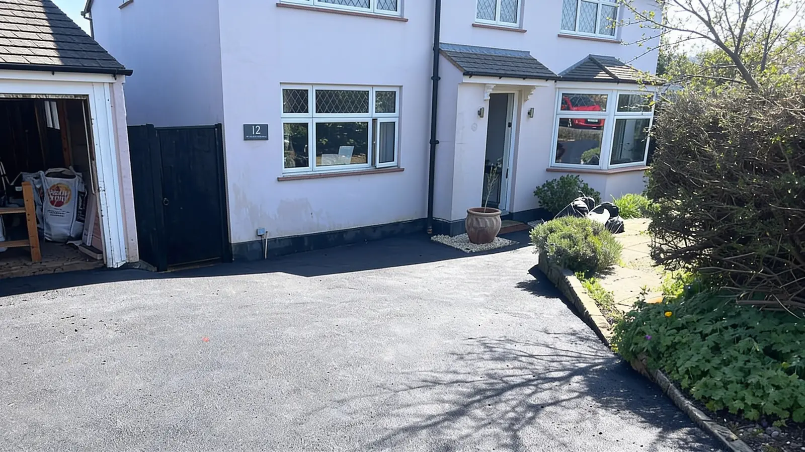 Freshly laid smooth tarmac driveway in front of a Surrey home